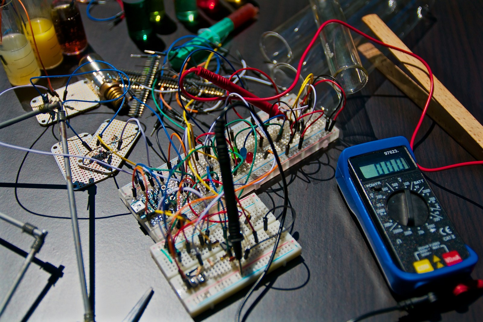 Breadboard prototype wired next to a multimeter