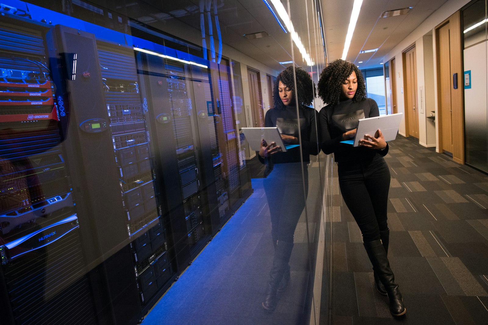 Engineer reviewing systems from a data center corridor