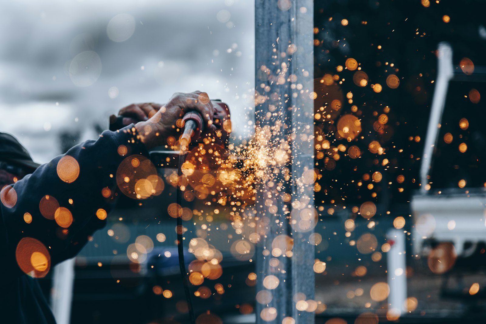 Sparks flying while grinding a steel section