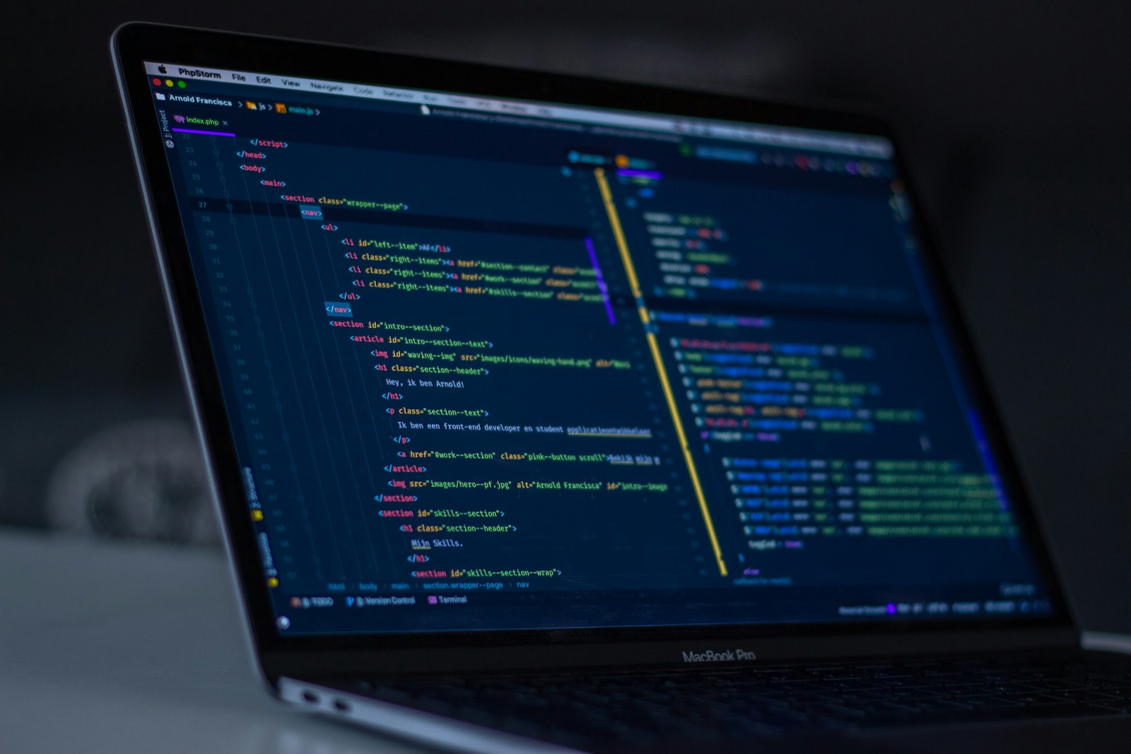Development environment open on a laptop in low light